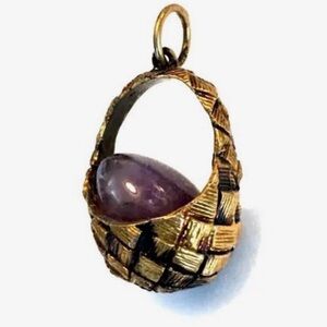 Antique fabrege egg pendent in a basket .